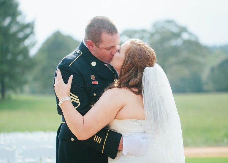 bride and groom kiss at southern military wedding