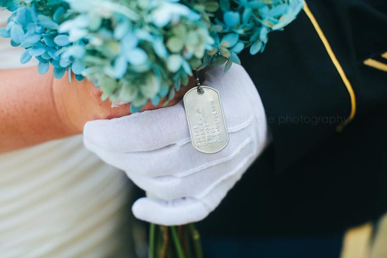 grooms dog tags on brides bouquet at military wedding
