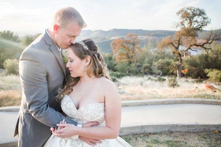 bride and groom overlooking oroville dam behind event center
