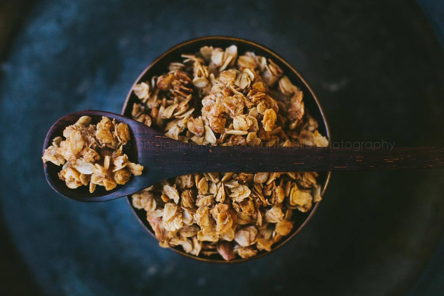 dark moody granola picture with wood spoon