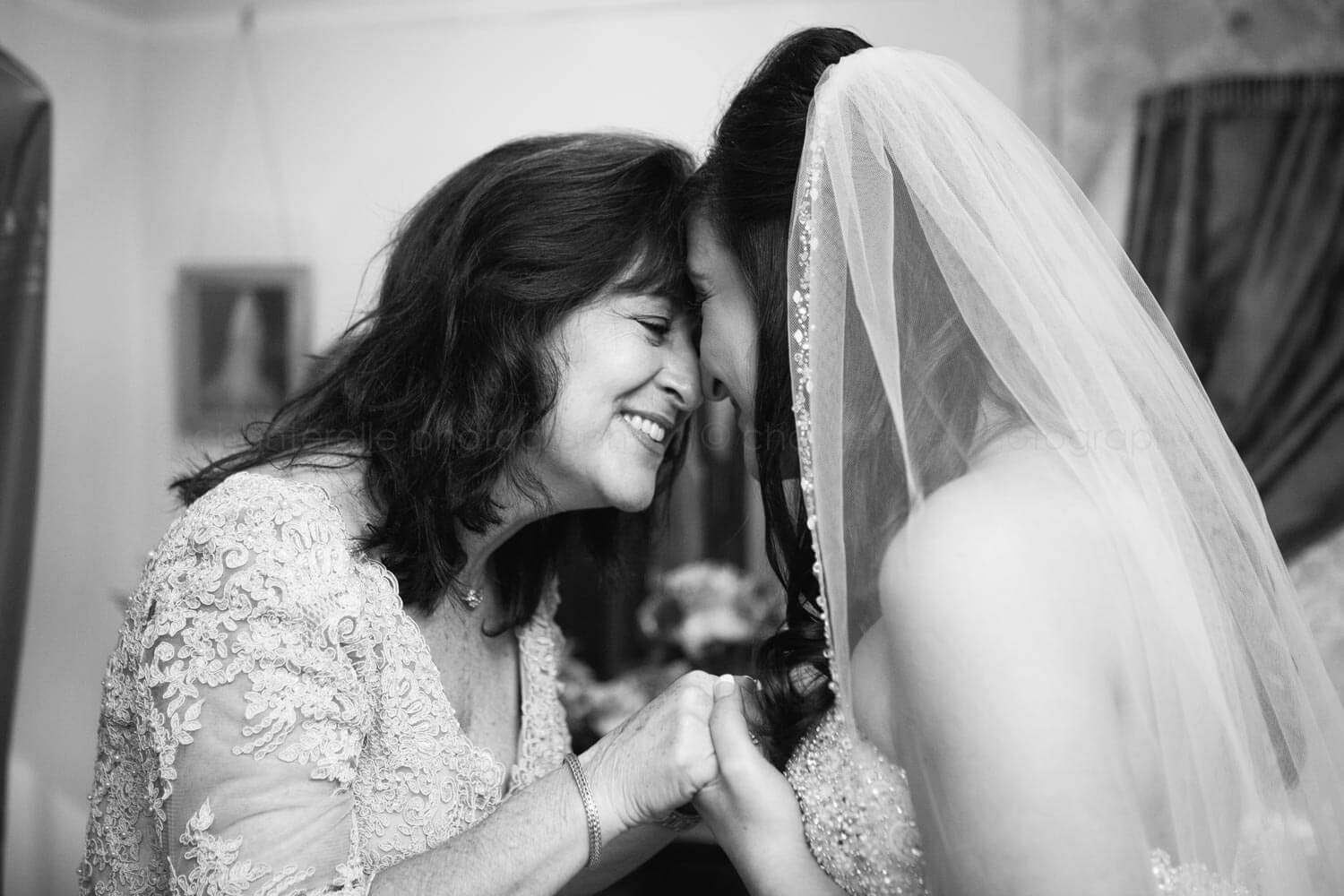 bride and mom having a moment before atlanta wedding