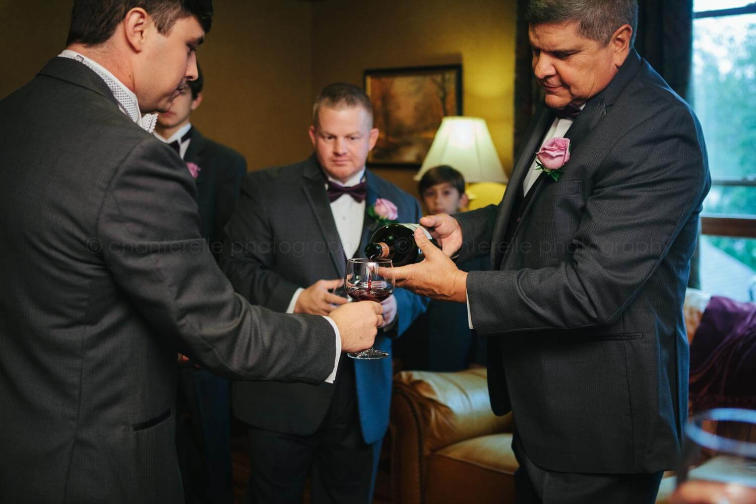 groom's father pouring wine before atlanta wedding