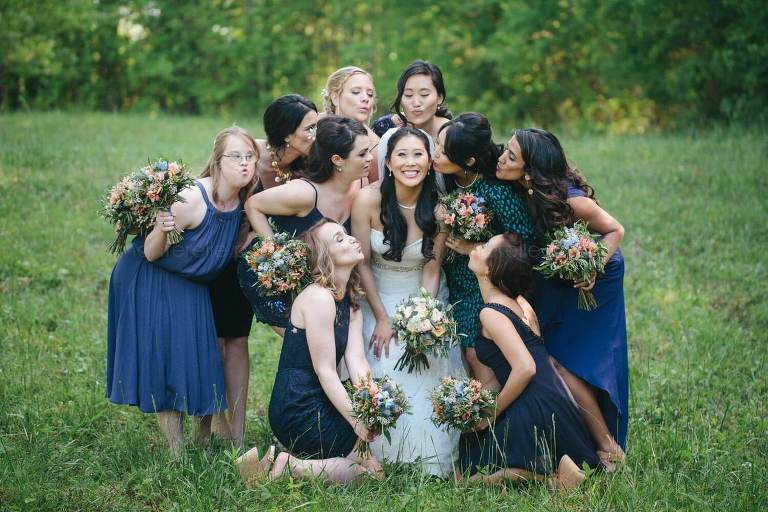 bride and bridemaids in navy dresses before rustic alabama wedding