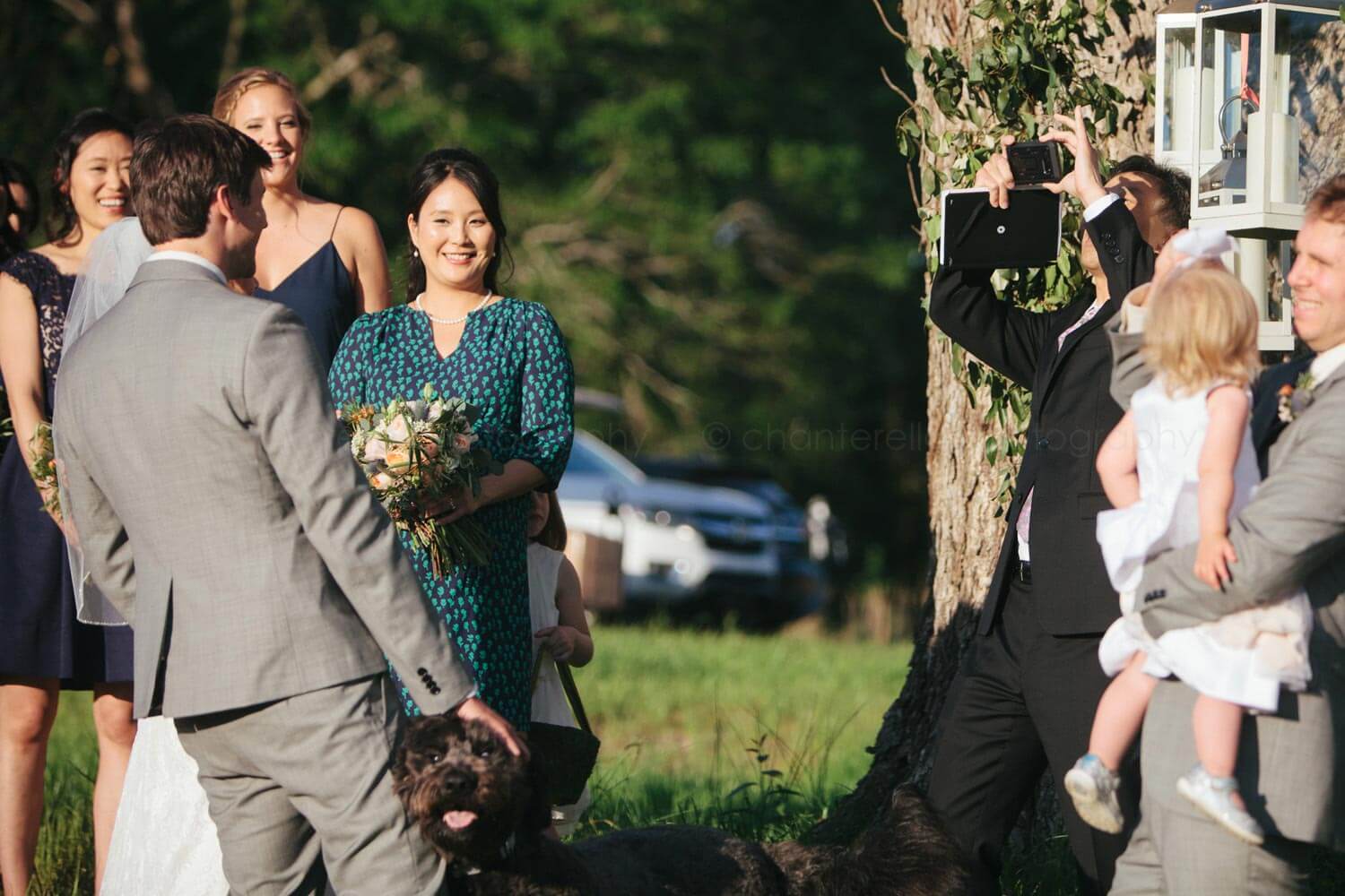 wedding officiant takes iphone picture of bride and groom during wedding