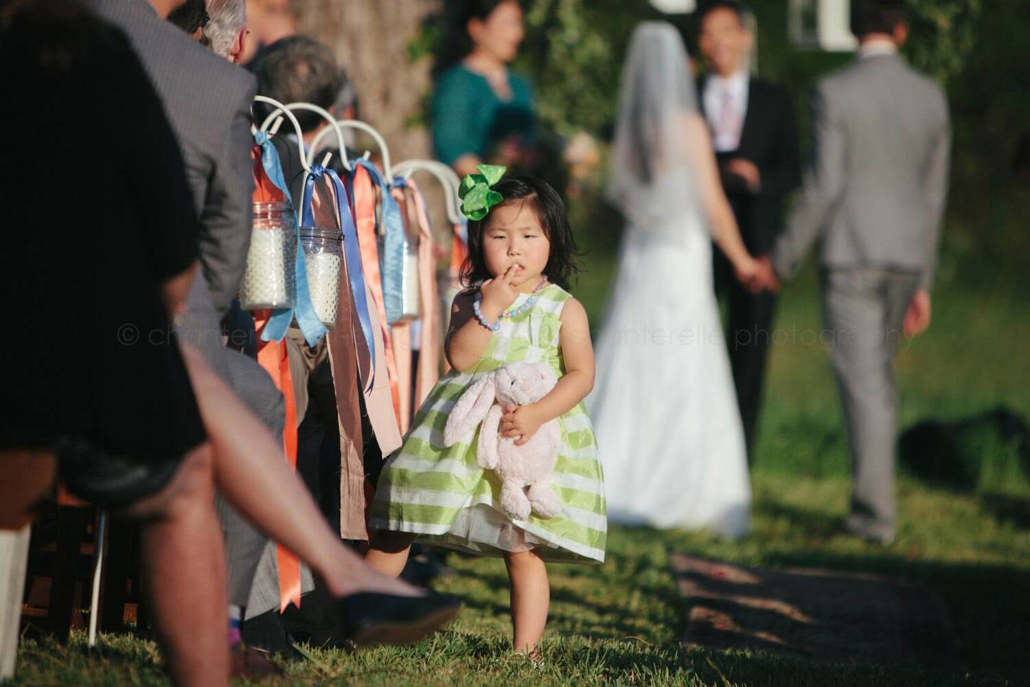 child wedding guest stands in aisle and flips bird