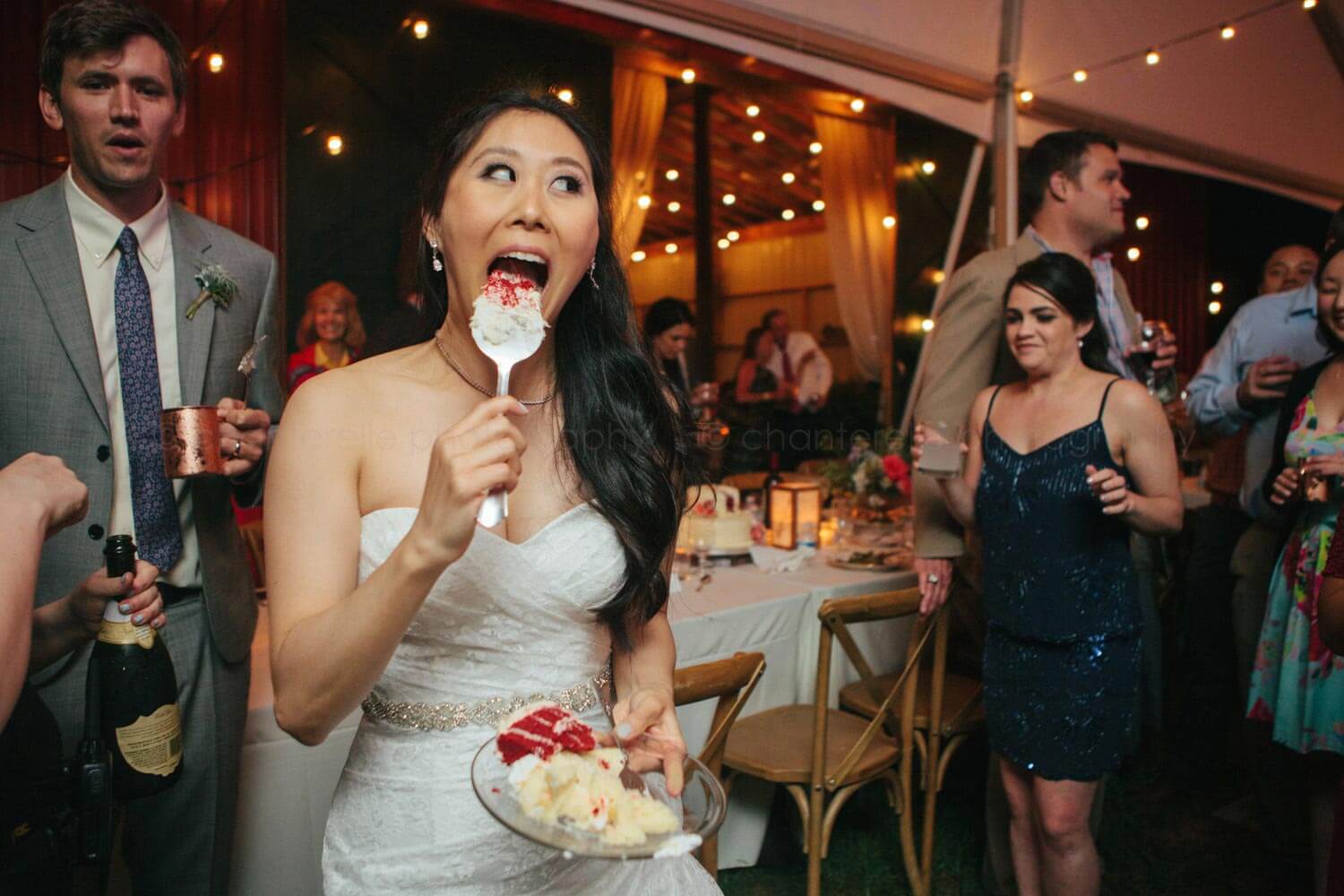 bride licking cake cutting server