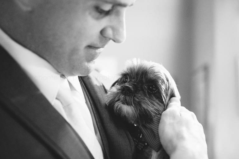groom holding his dog before key west wedding