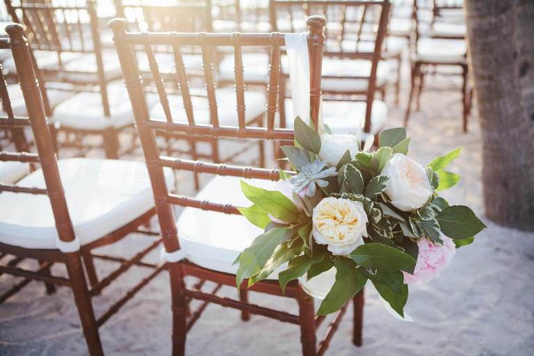 peony floral arrangement on chairs at florida beach wedding