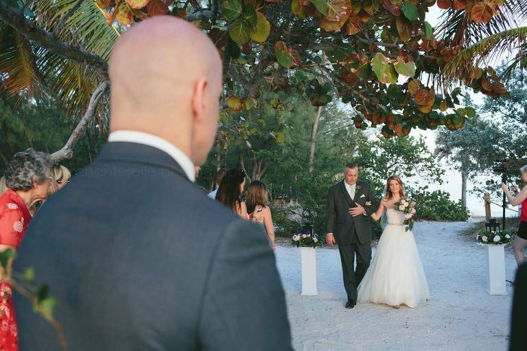 groom waiting for bride as she and her father walk down the aisle at fort zachary taylor beach wedding