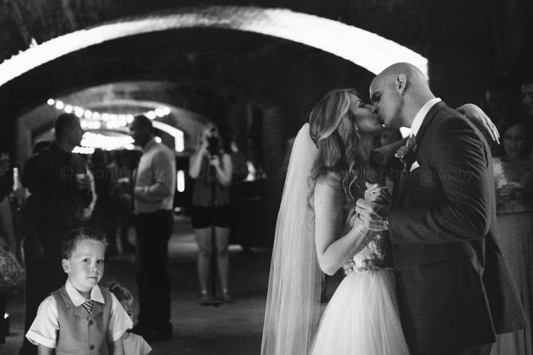 bride and groom kiss during first dance at fort zachary taylor wedding