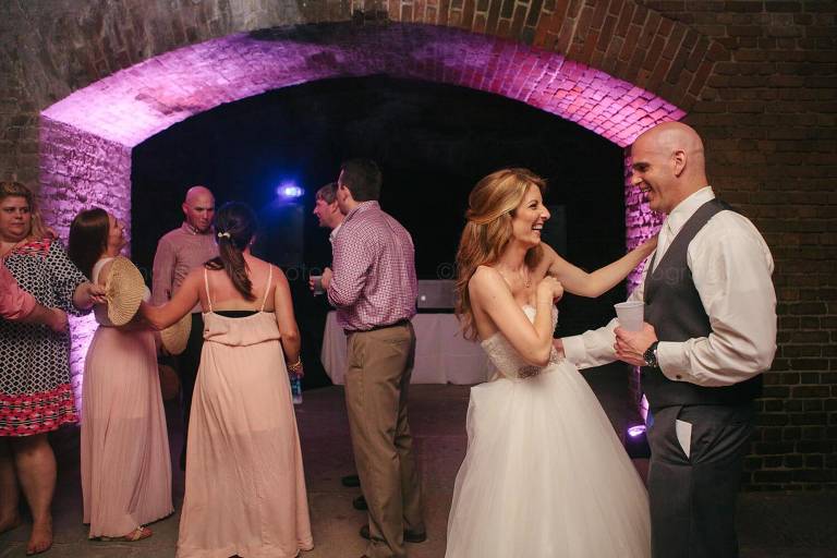 bride and groom laughing at fort zachary taylor wedding reception