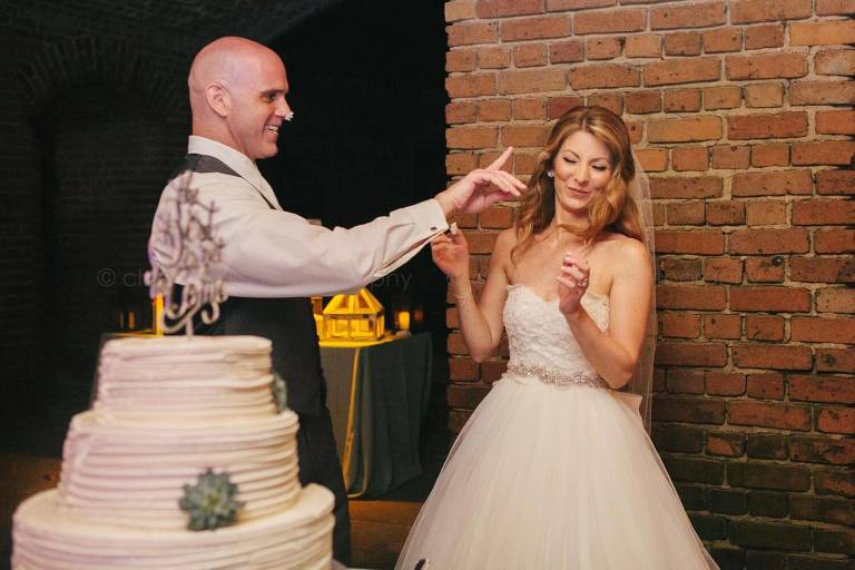 groom teasing bride with wedding cake frosting at key west reception