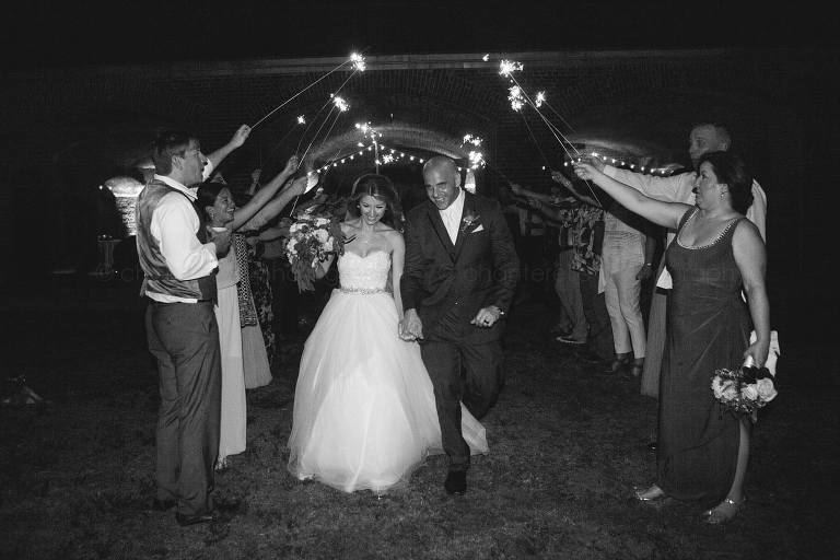 bride and groom leave fort zachary taylor under sparklers