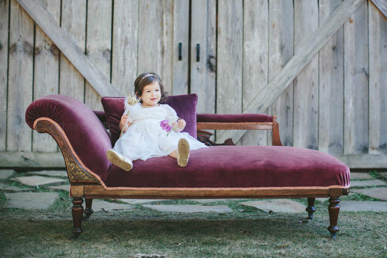 baby on purple velvet chaise