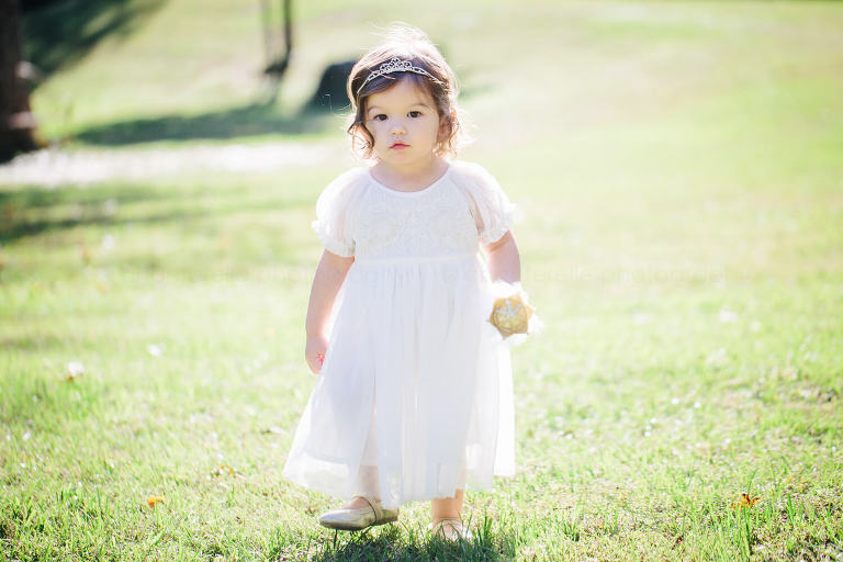 baby in white dress at barn at pisgah hill