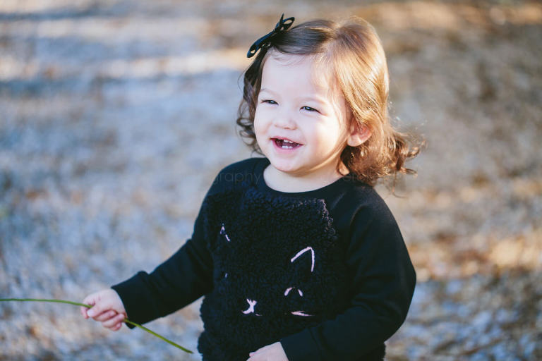 laughing baby wearing cat sweater