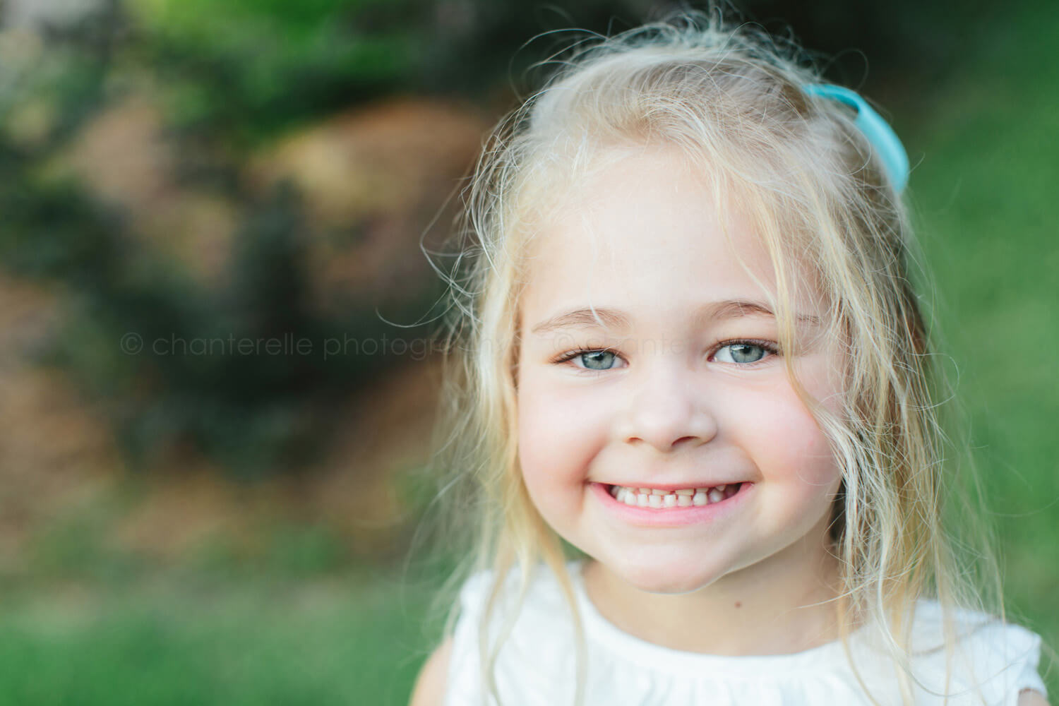 little blond girl smiling at lake martin photo session