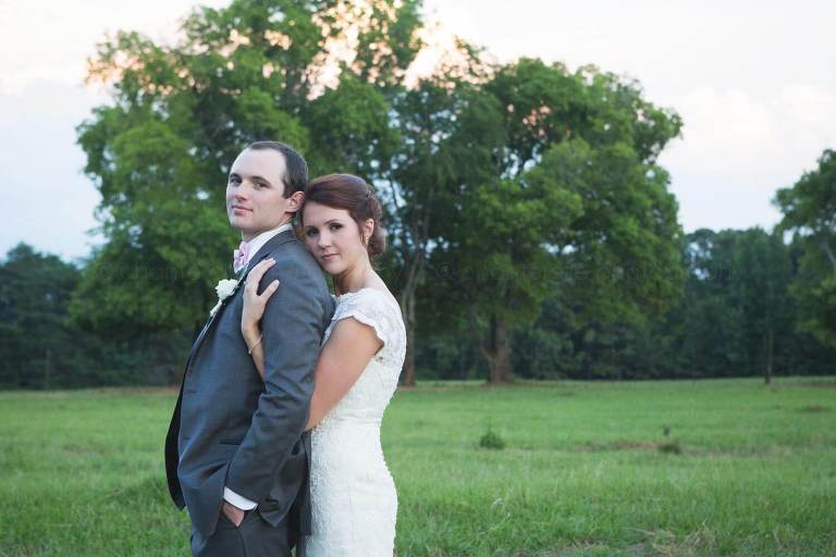bride and groom in pasture at rocky mount