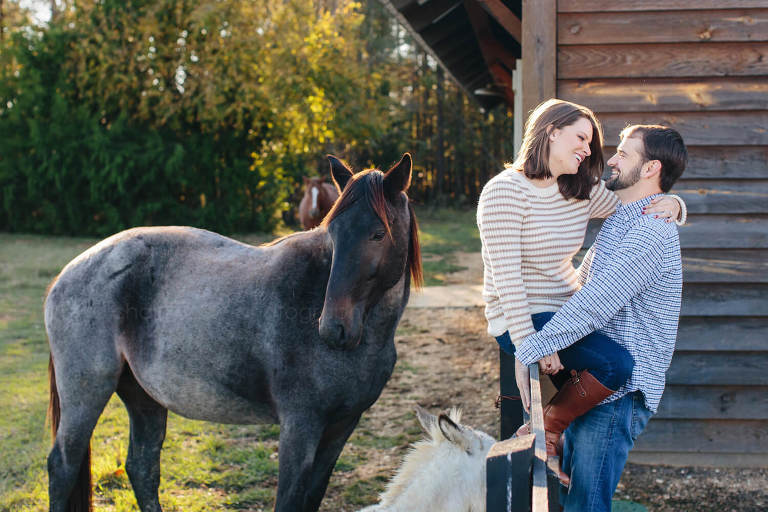 couple with horses during alabama engagement session