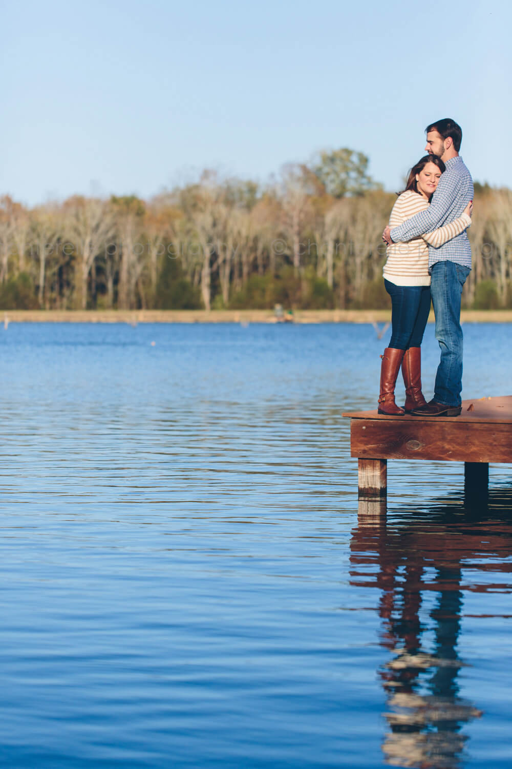 couple on dock in alabama engagement pictures