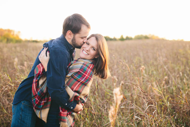 couple in field during fall engagement session outside montgomery