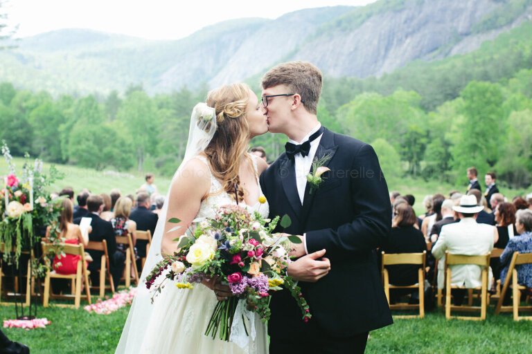 bride and groom kiss as they exit highlands north carolina wedding ceremony