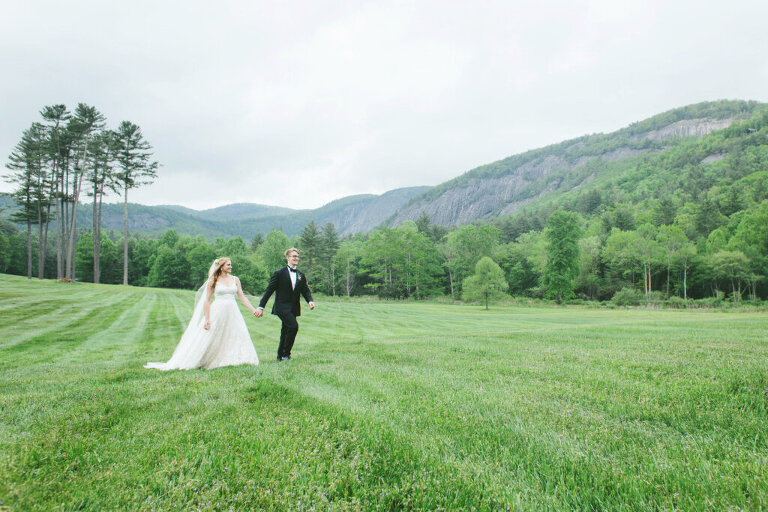 bride and groom walking through lonesome valley after wedding