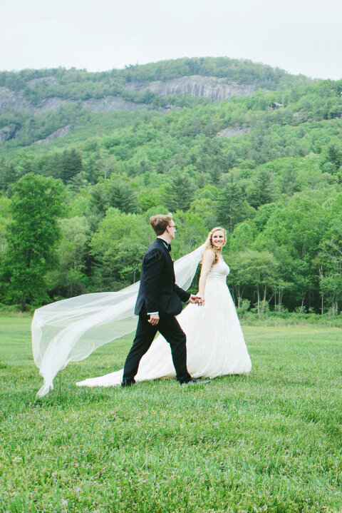 bride and groom with veil blowing in lonesome valley