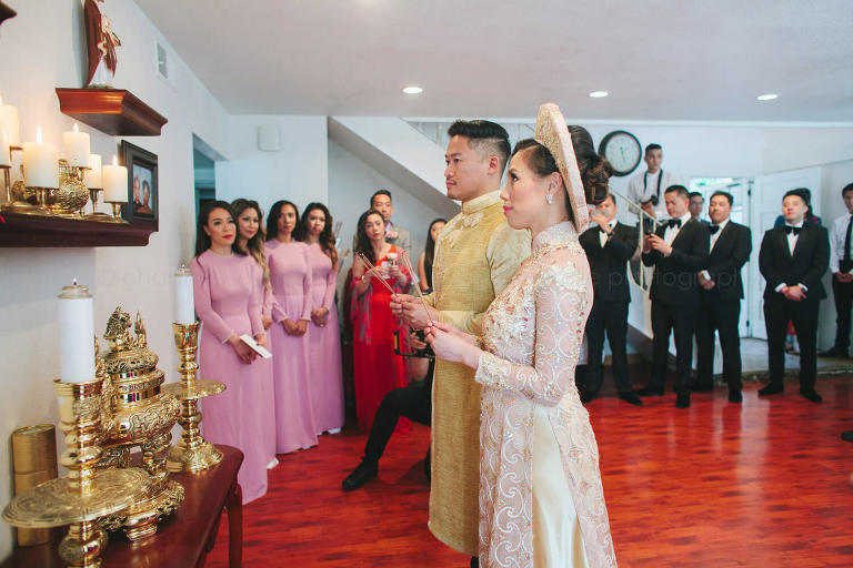 bride and groom pray during vietnamese wedding ceremony