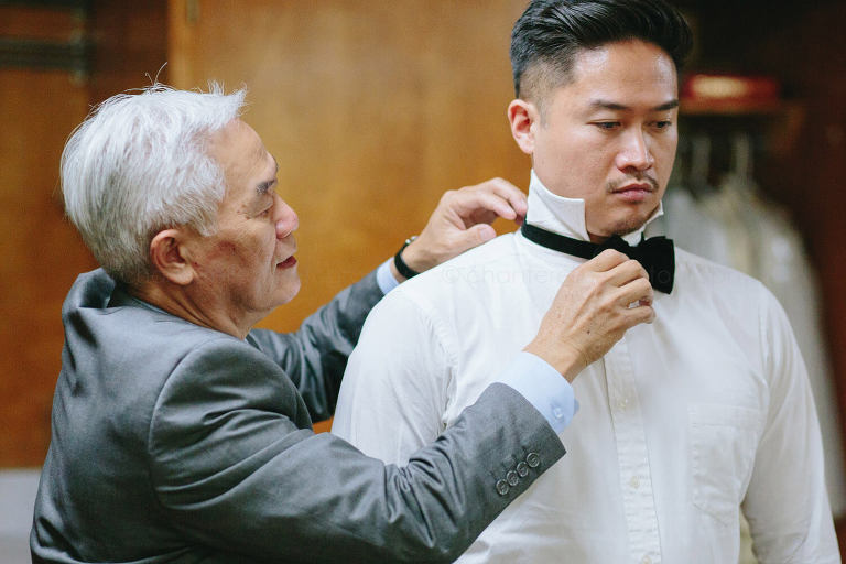 dad helping groom get ready before tustin wedding