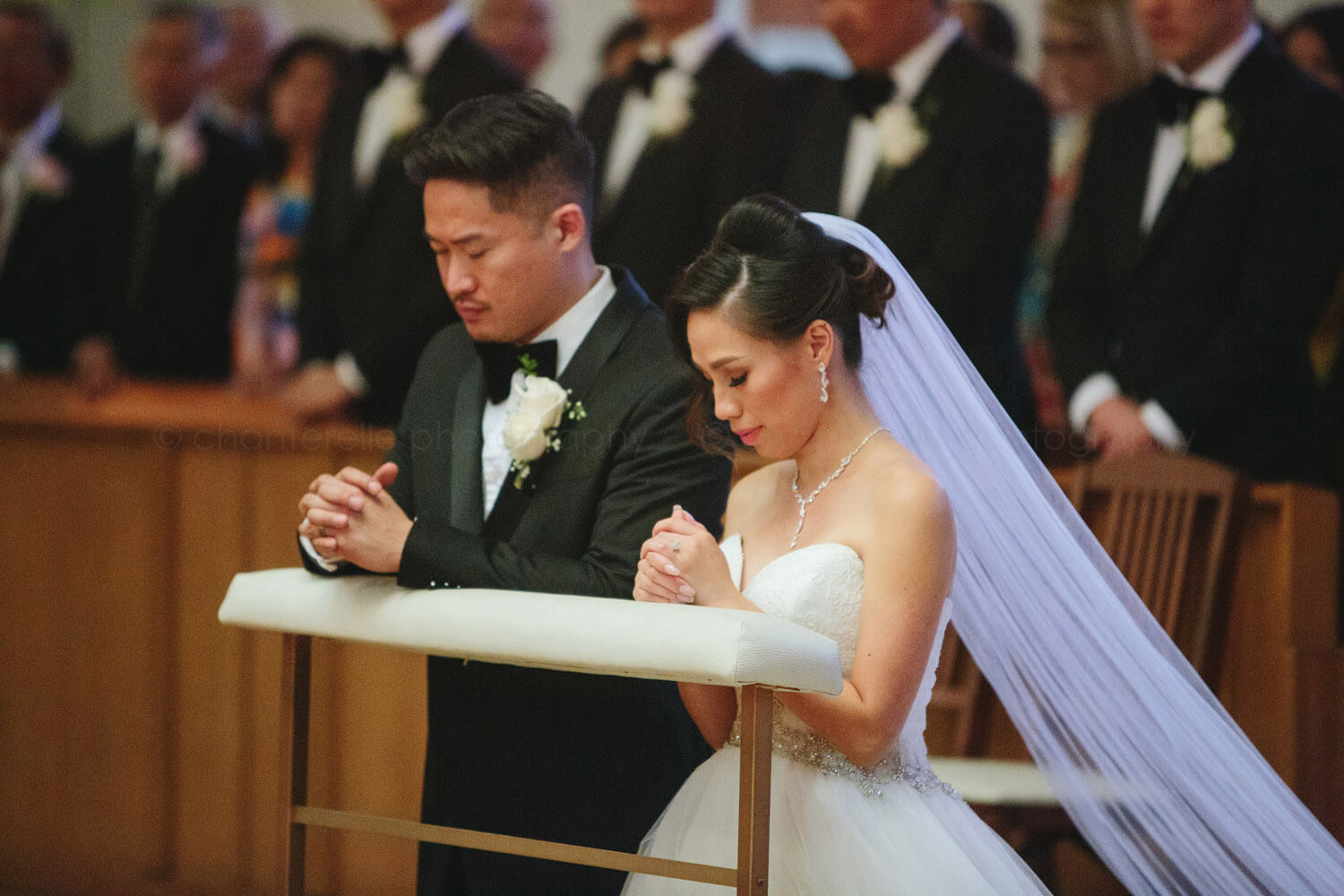 bride and groom pray during tustin church wedding
