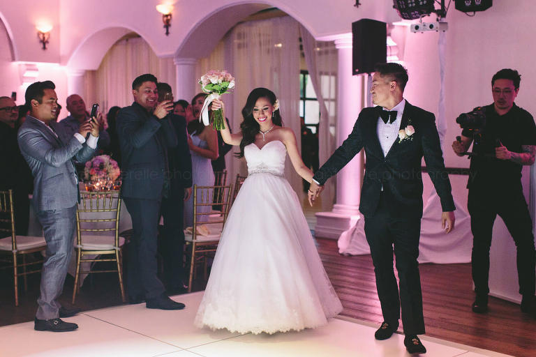 bride and groom enter reception at the villa