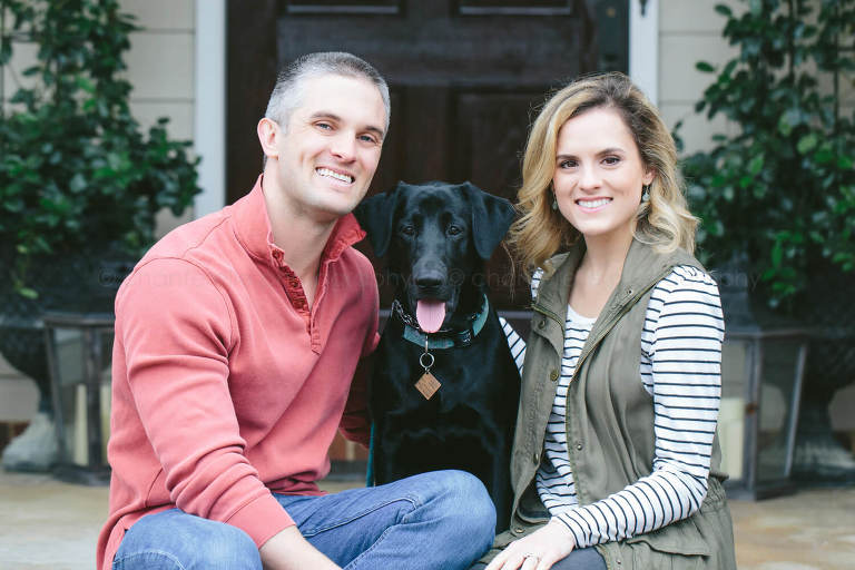 portrait of couple with black dog