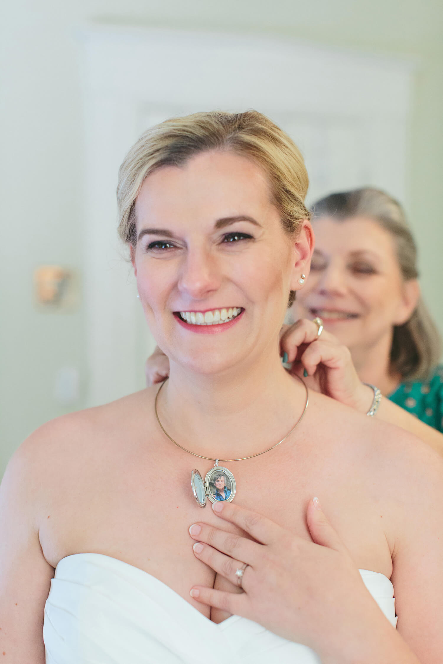 bride wearing locket with fathers picture