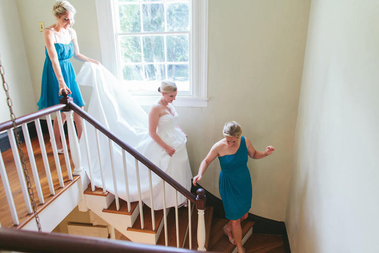bride and bridesmaids walking down stairs