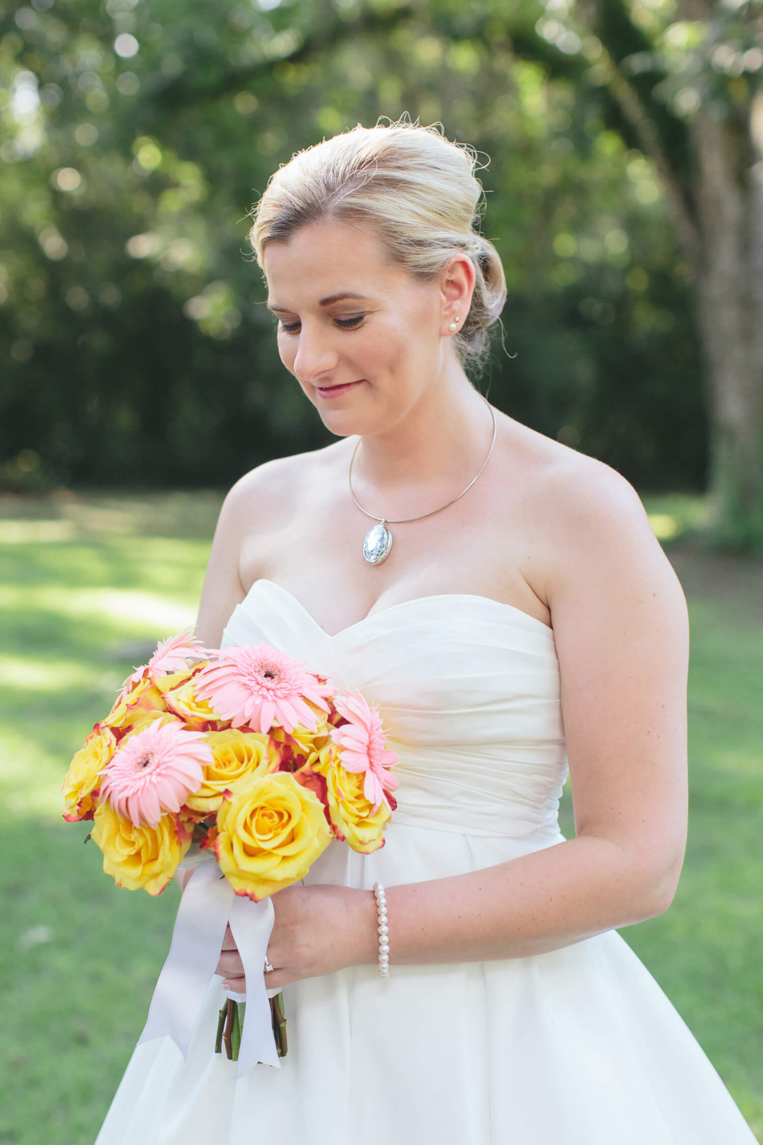 bride looking at bouquet before millbrook wedding