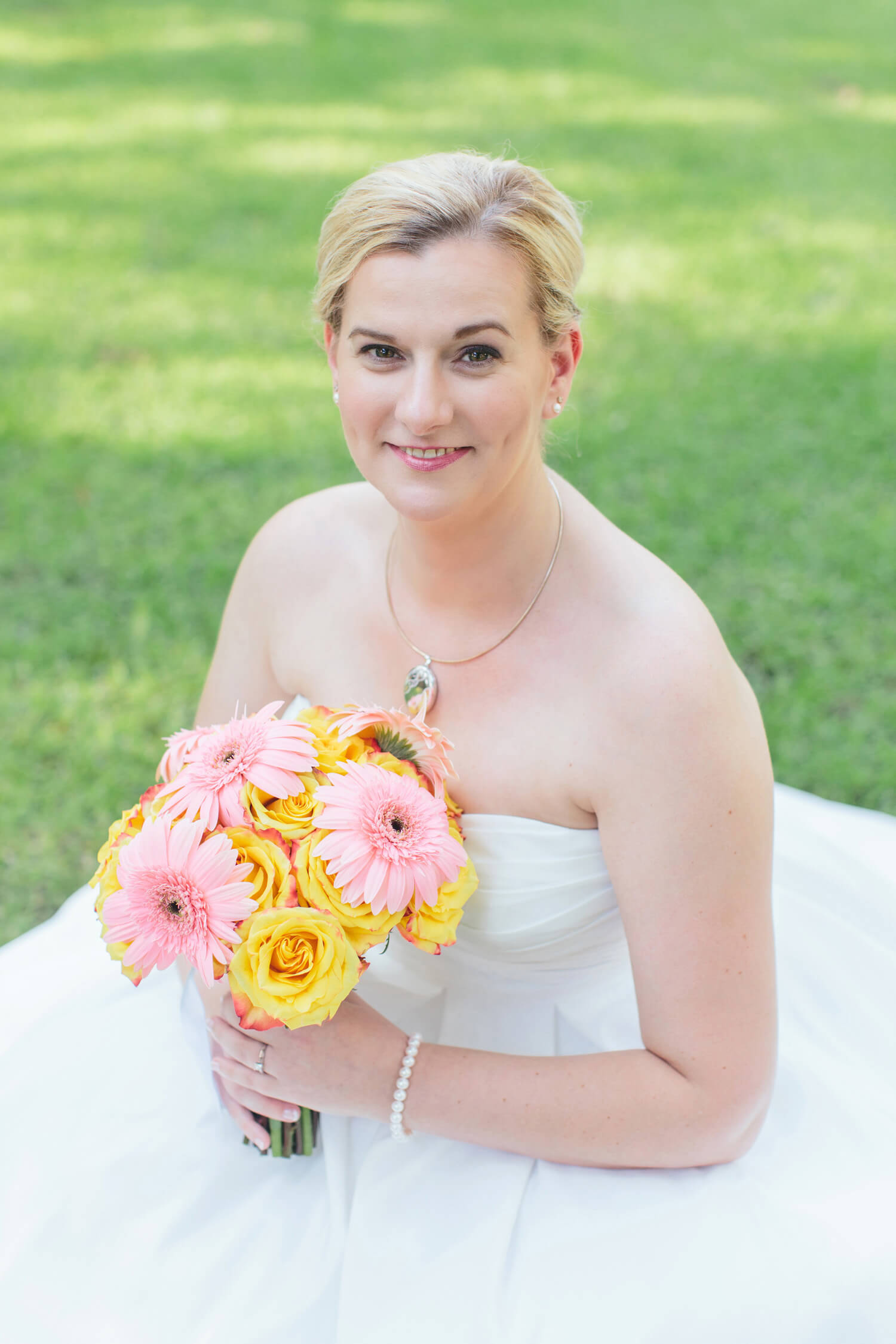 bride with pink and yellow wedding bouquet