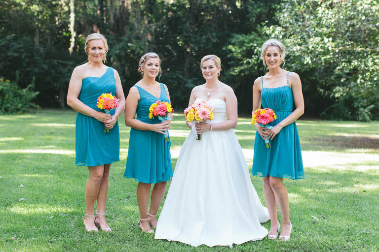 bride with bridesmaids in teal dresses