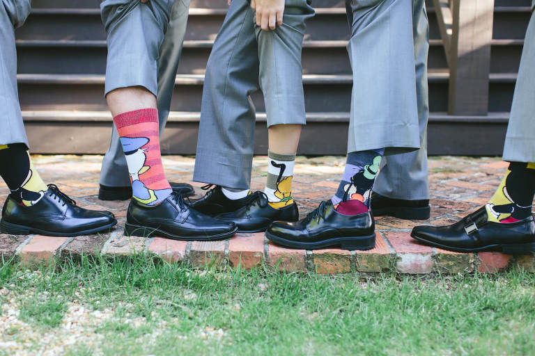 groom and groomsmen wearing disney socks