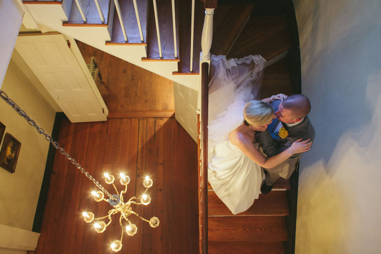 bride and groom on the stairs at the elms