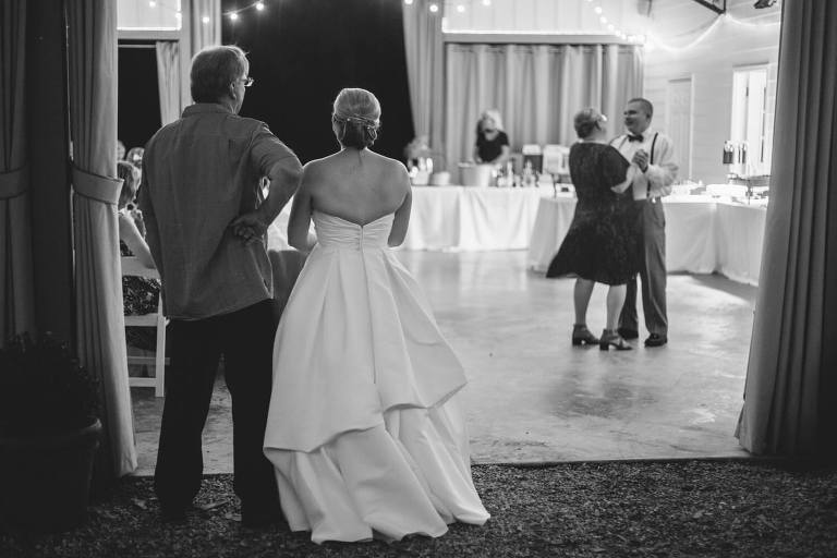 bride watching as groom dances with his mother