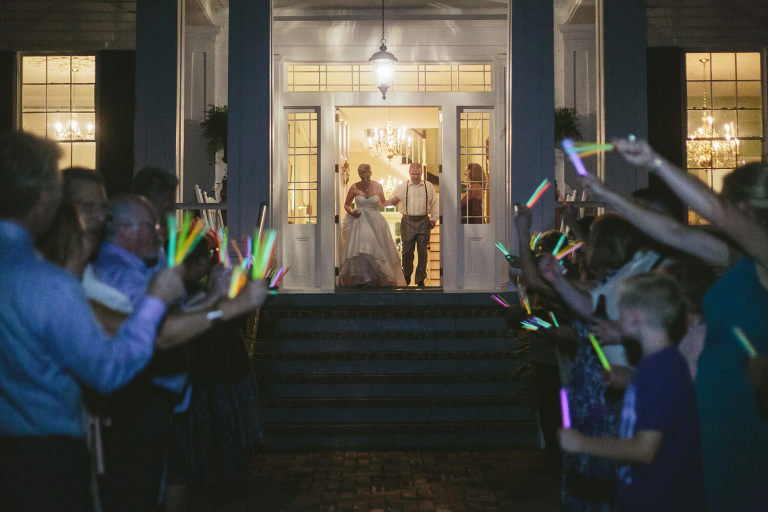 bride and groom exit the elms with glow sticks