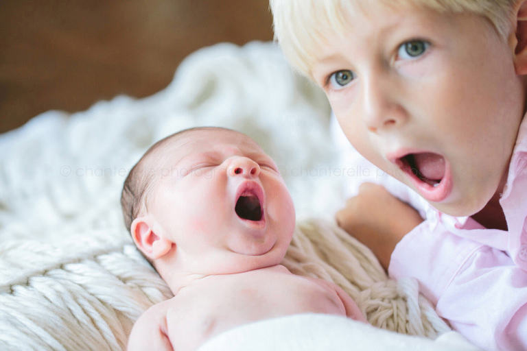 newborn and big brother yawning
