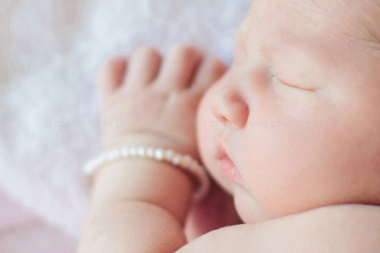 newborn baby girl wearing tiny bracelet