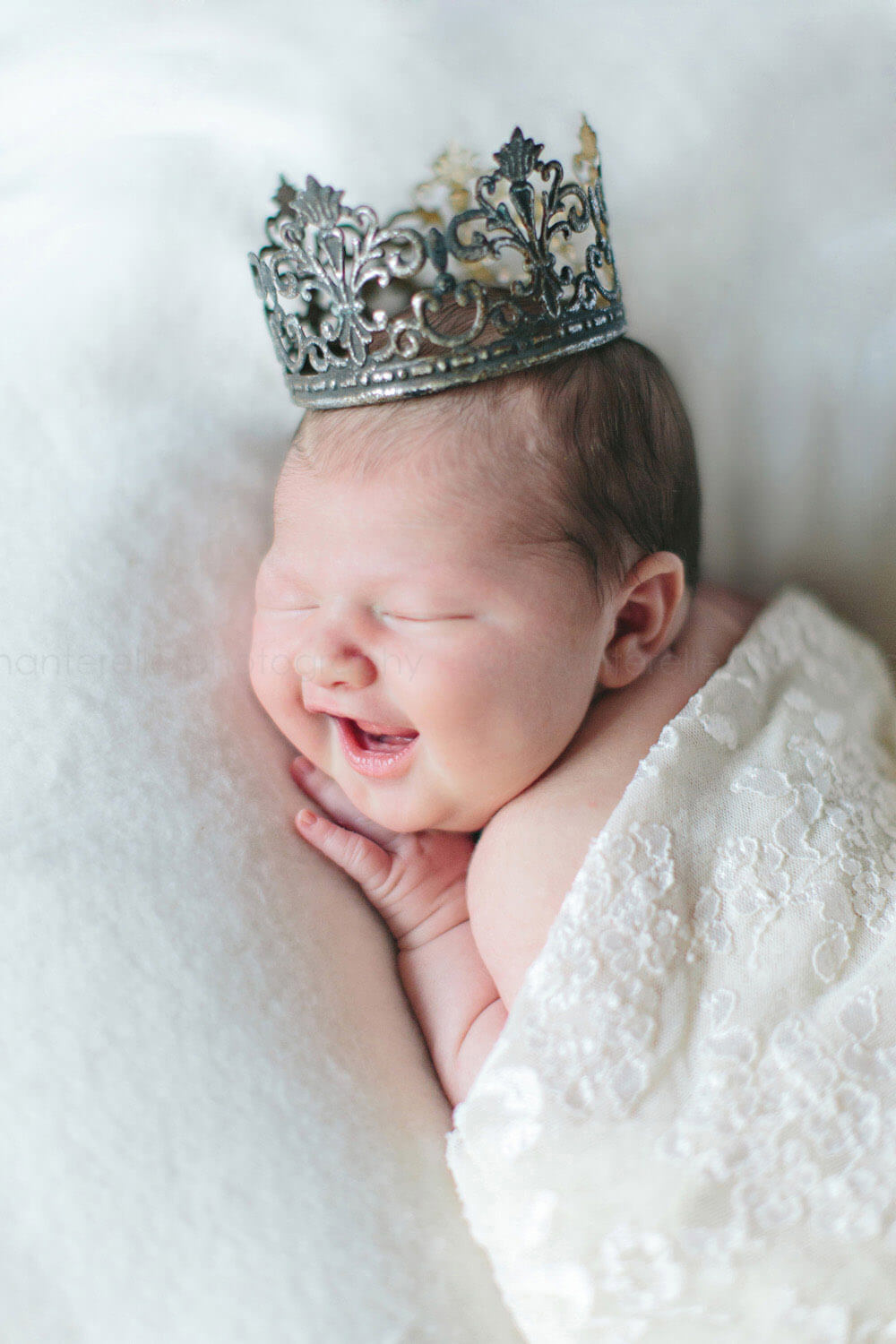 newborn smiling while wearing crown in montgomery alabama