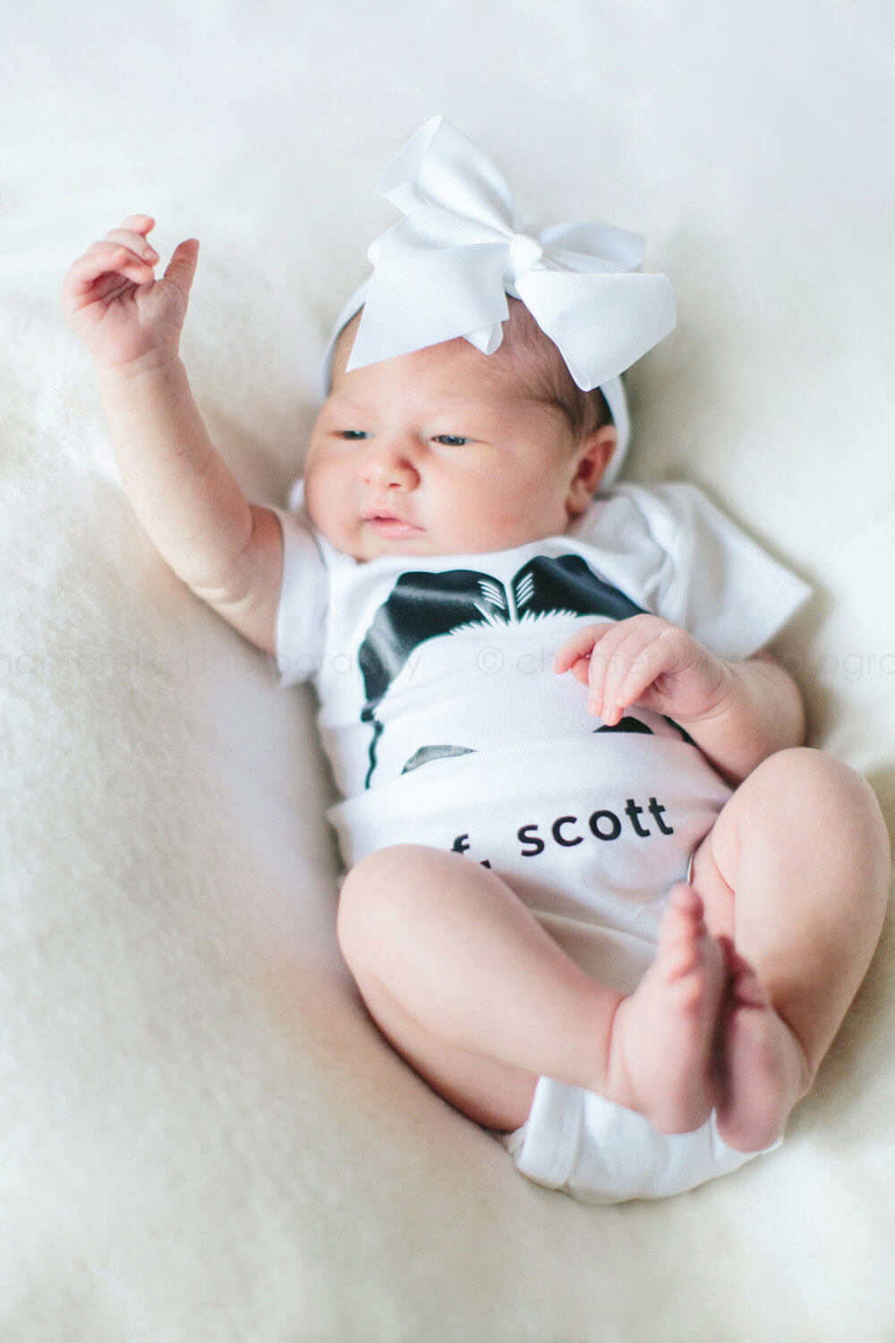 baby wearing f scott fitzgerald onesie