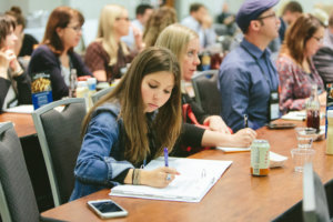 attendee taking notes at ifec conference