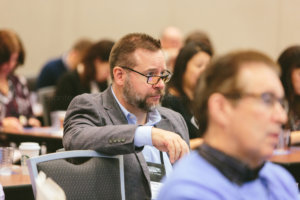 attendees listen to ifec conference speaker