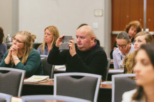 attendees taking photos at ifec conference