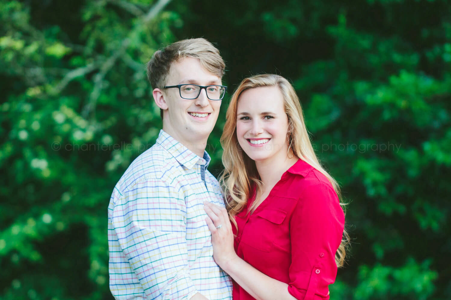 couple smiling at camera for engagement pictures